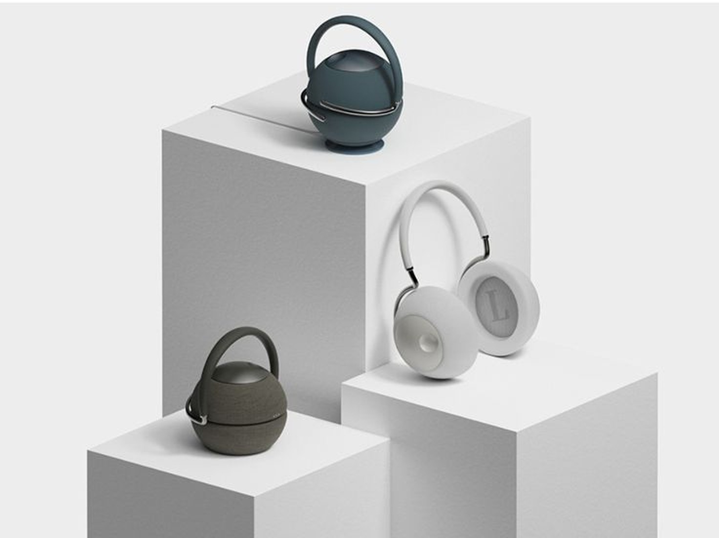 Reson speakers and headphones on white plinths